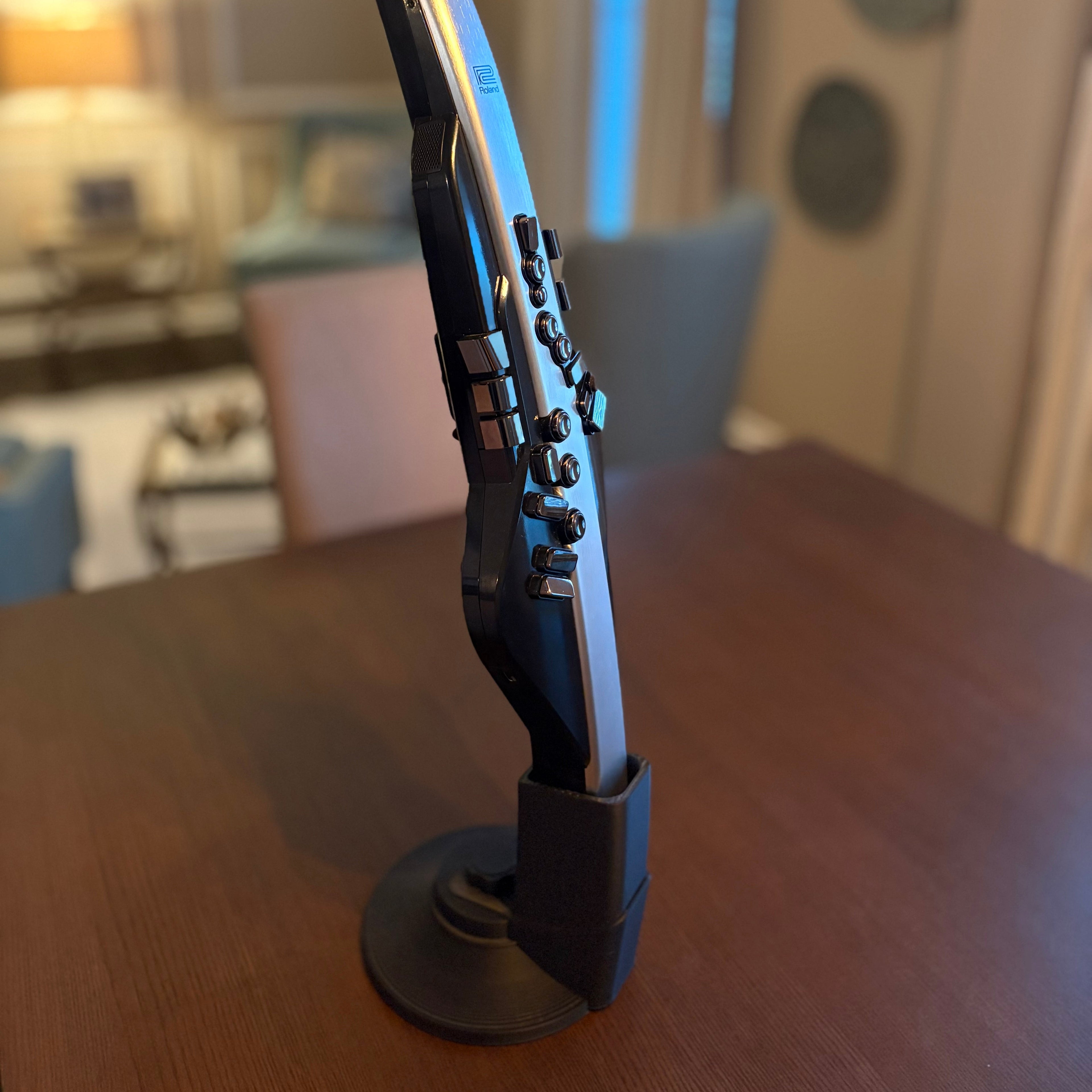 Black and silver electronic device on a wooden surface with a blurred background